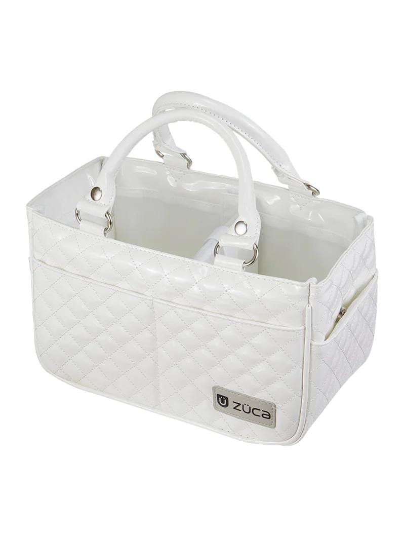 White quilted tote with 2 carry handles and a compartment. Bag stays open, no closure. Easy access opening. Shinny Finnish on the interior.