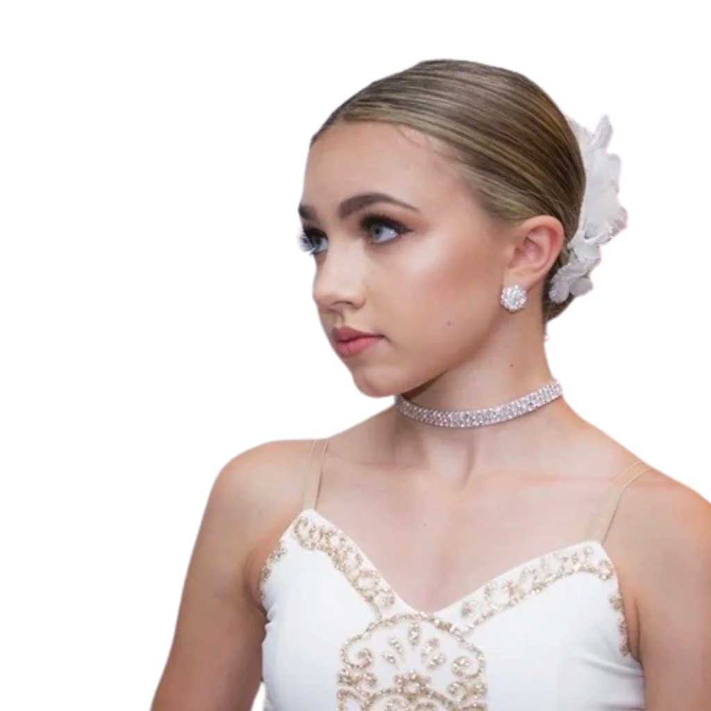 young dancer ready for dance competition in costume wearing makeup and jewelry